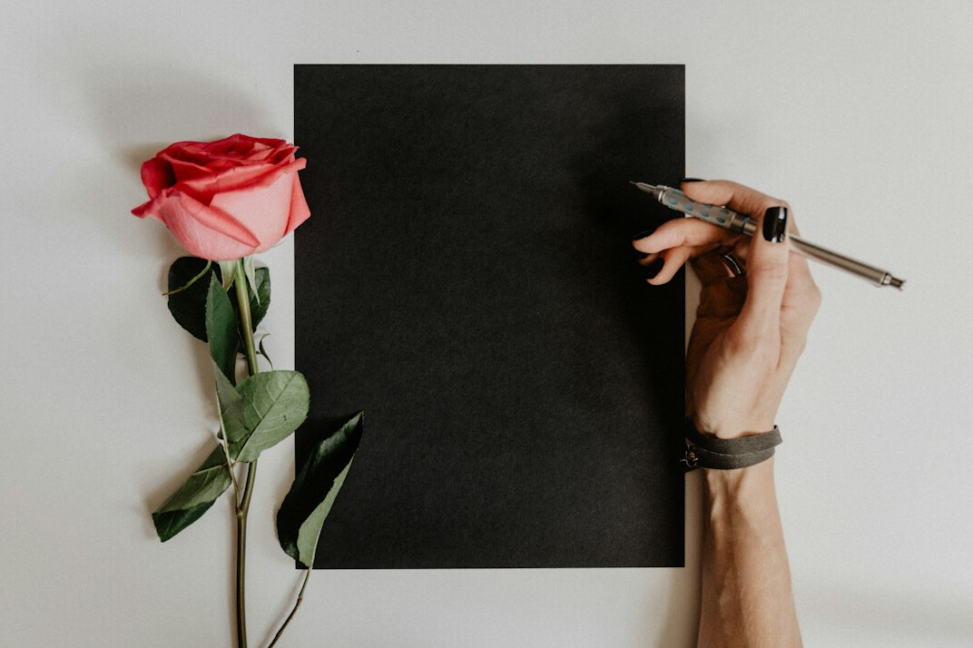 Hand writing notes with a pen on paper