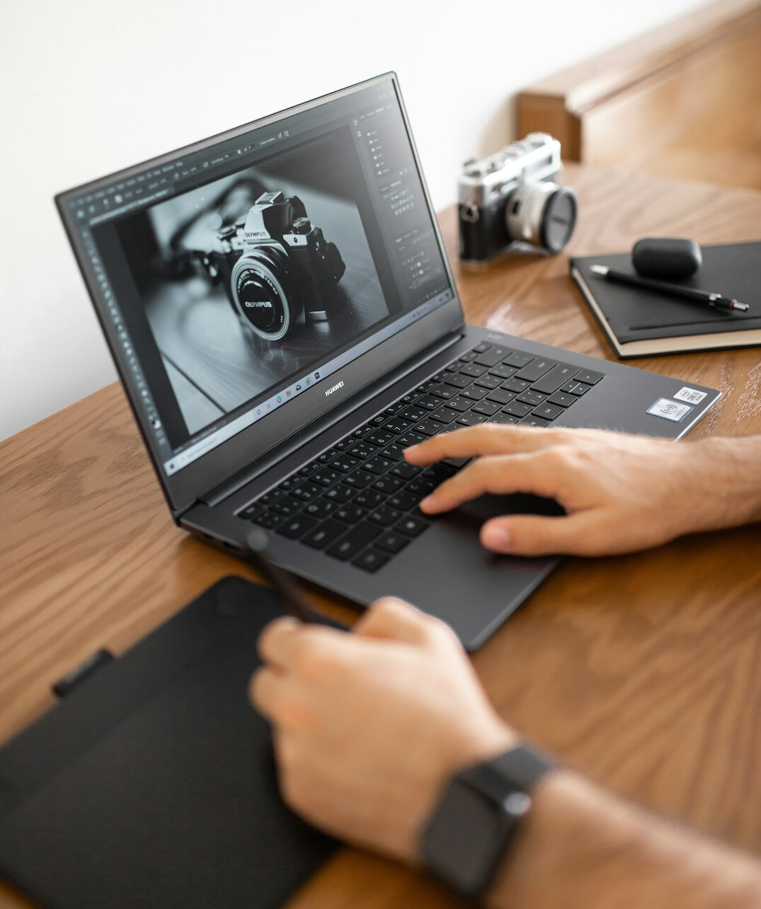 Hands typing on a laptop keyboard